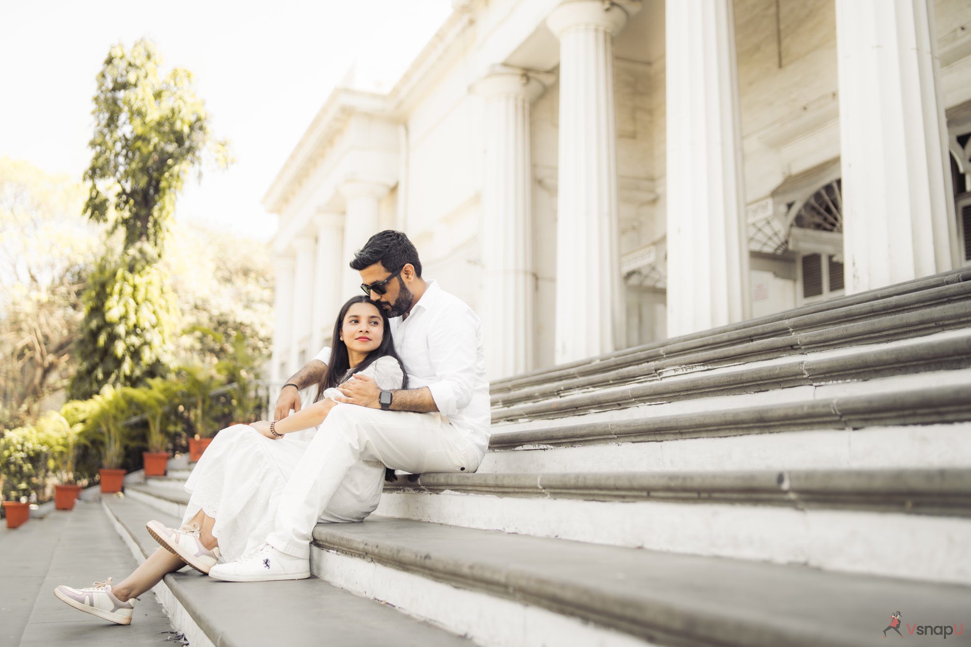 Couple wrapped in love on stairs by professional photographer in Aligarh